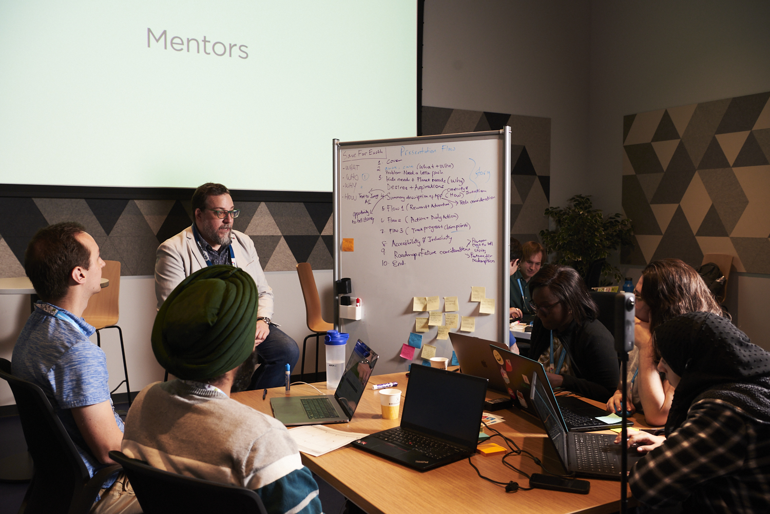 A mentor speaks to a group of participants at the Ingenium Innovation Challenge