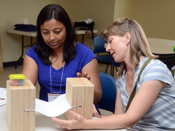 Two teachers conduct a hands-on experiment