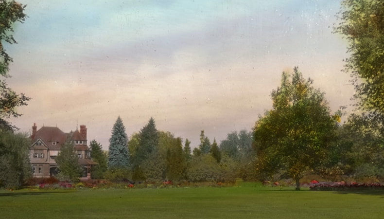 Scenic image of Canada's Central Experimental Farm, with green grass, trees, a historic barn and colourful pastel sky