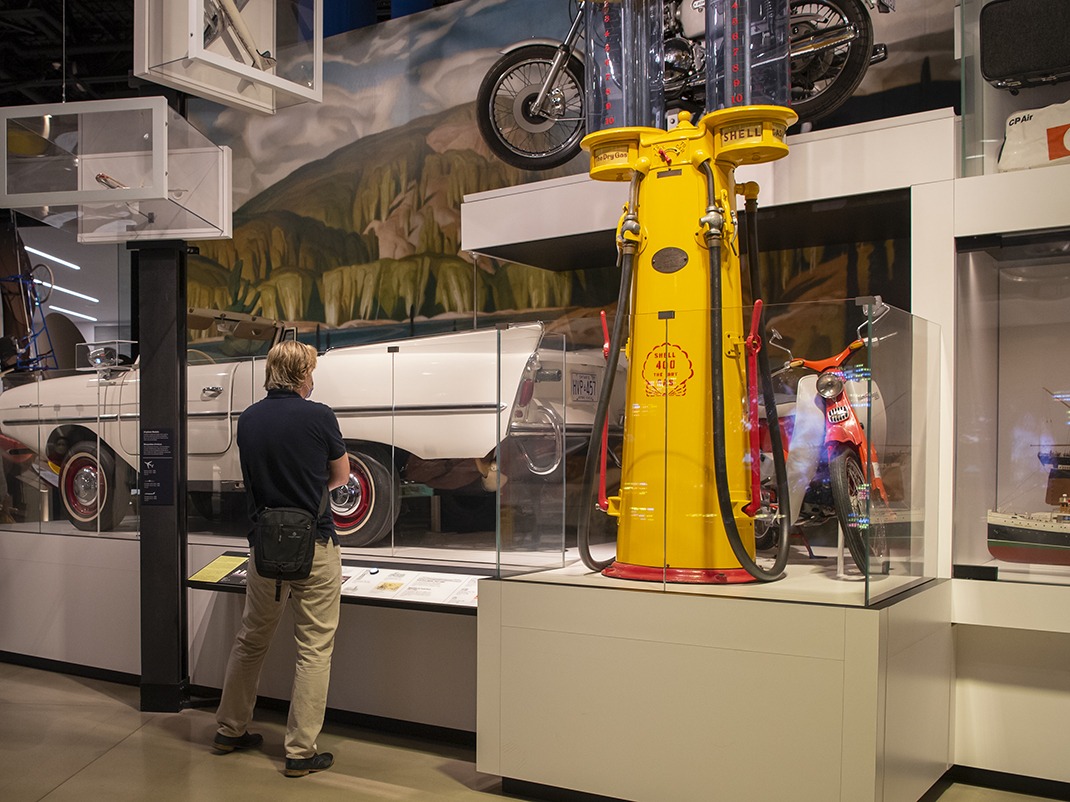 Visiteur devant des véhicules anciens